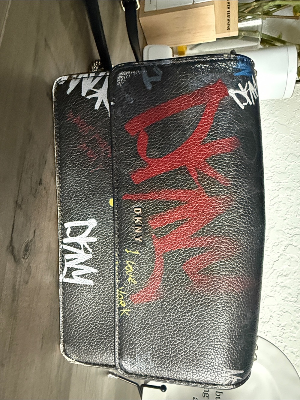 DKNY Black Leather Messenger Bag with Red Graffiti and White Accents